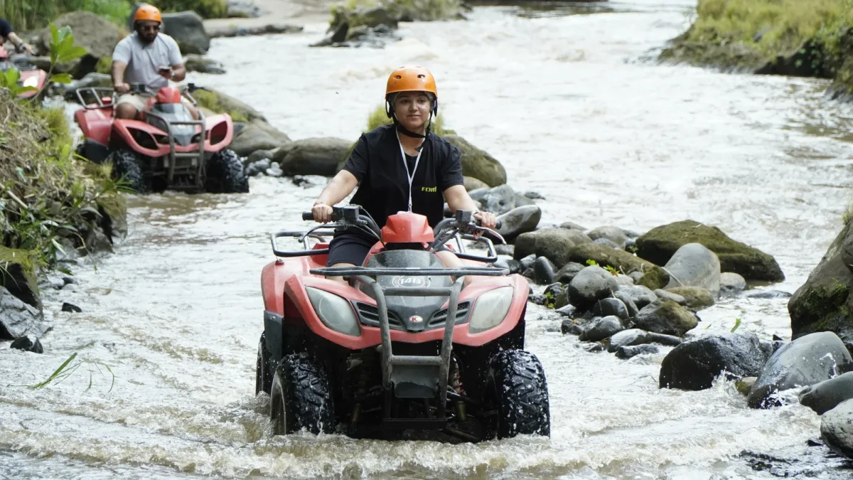 ATV rider crossing a river section